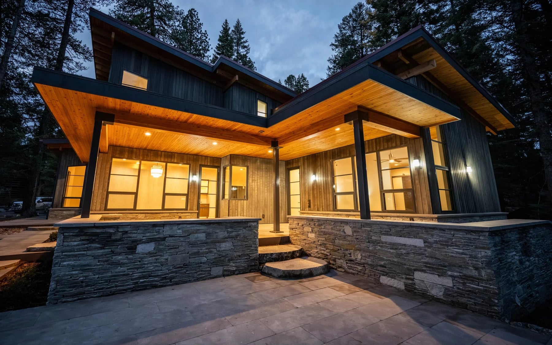 Modern Elegance: a modern custom home with tall windows and stone